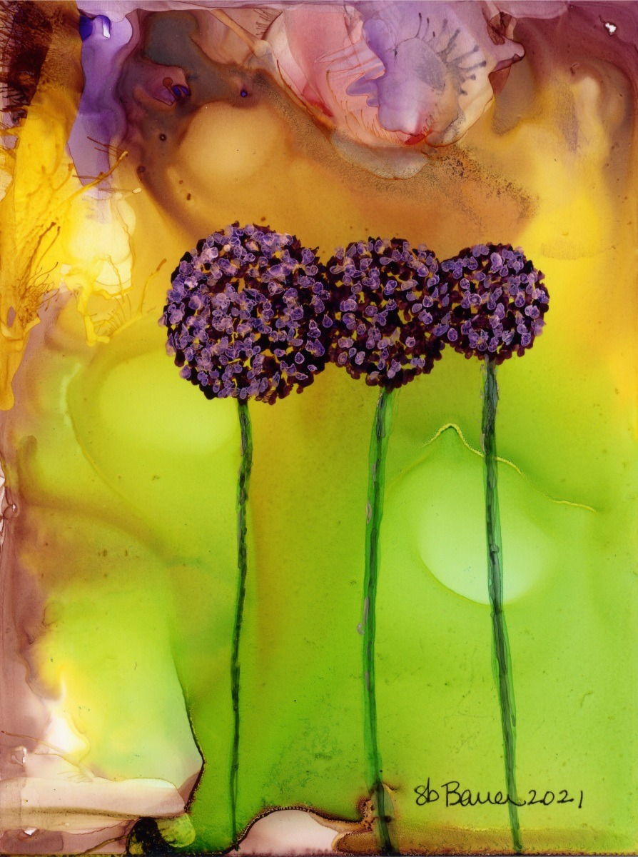 Three vibrant purple flowers on green stems are set against a colorful, abstract background of warm yellows and soft pinks, highlighting artistic floral beauty.